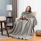 Woman reading in an armchair in a light gray plain flannel sleeved blanket, Flannel light gray option