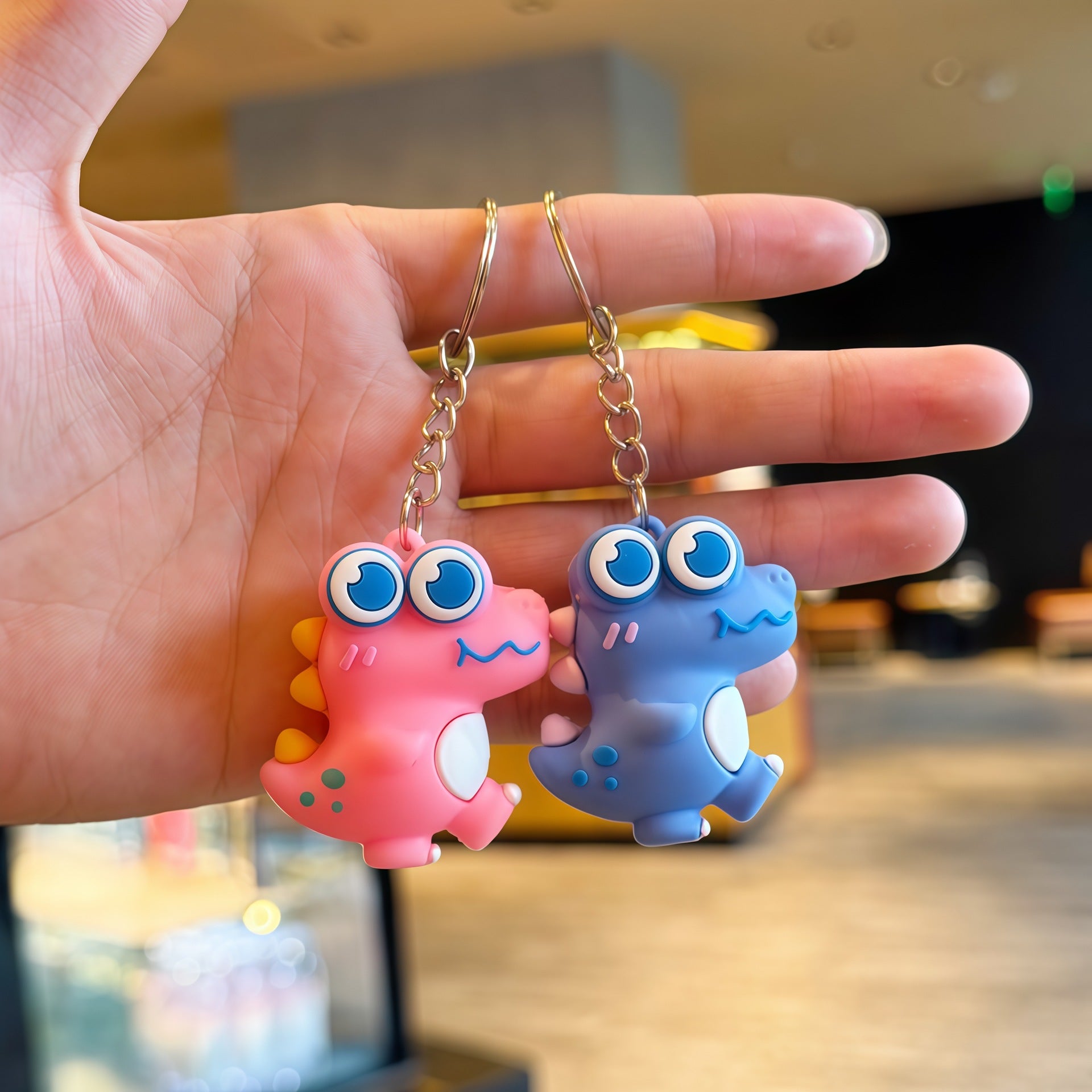 Cartoon dinosaur keychain charm side profile showing molded edges