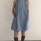 Light blue loose A-line dress with front pockets styled with knee socks, full length