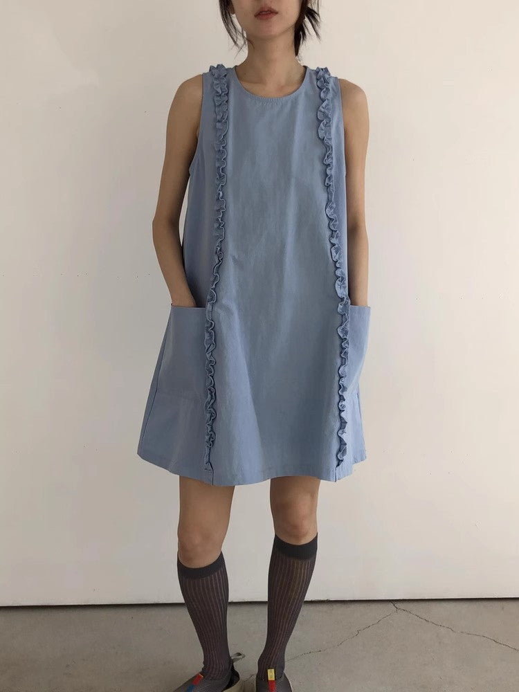 Light blue loose A-line dress with front pockets styled with knee socks, full length