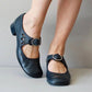 Blue Mary Jane shoe with a buckle strap, petal cut outs and a low block heel, side view, size 40 option
