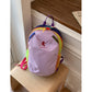 Light purple color block backpack on a wood stool, contrast straps, top handle and rainbow trim