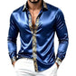 Blue satin long sleeve shirt with a gold ornamental band down the placket and cuffs on a white background