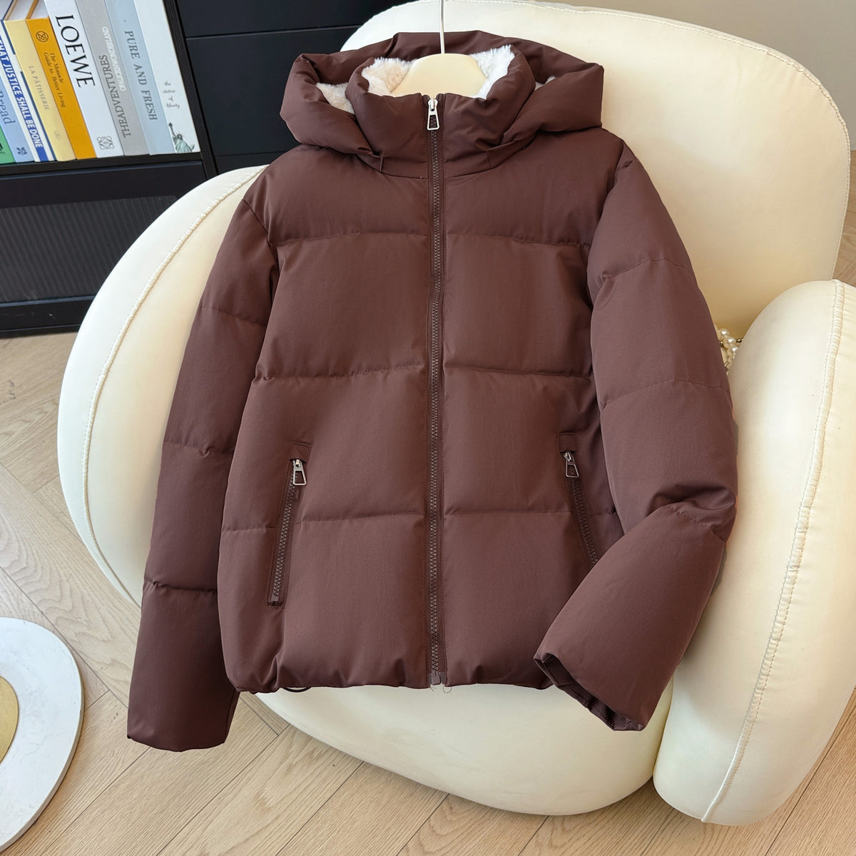 Short puffer jacket shown open to reveal the plush fleece lining and stand collar