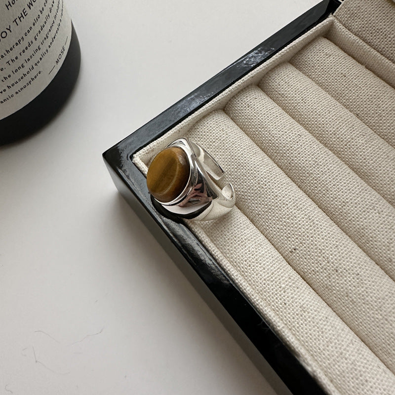 Tiger eye stone ring resting in a jewellery tray