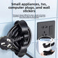 Black cord winder stuck to a toaster holding the wrapped power cord and plug