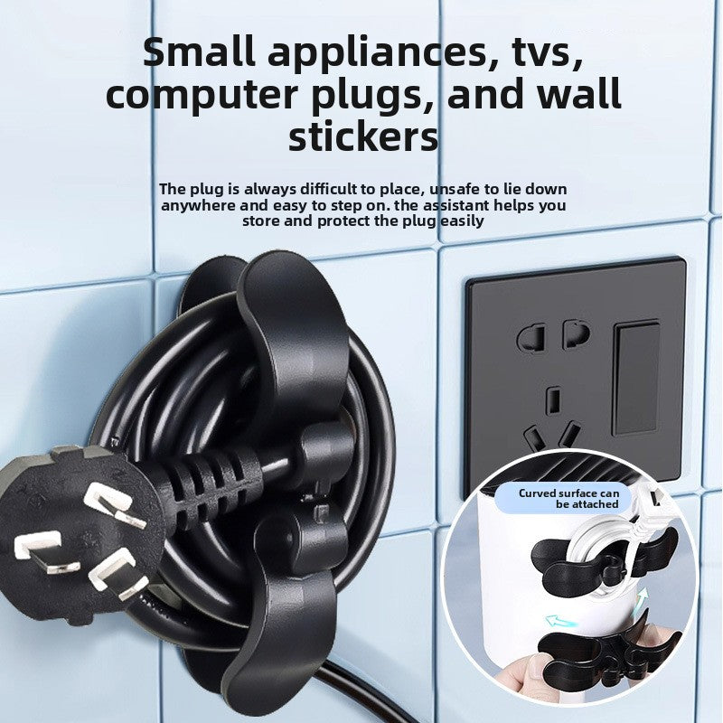 Black cord winder stuck to a toaster holding the wrapped power cord and plug