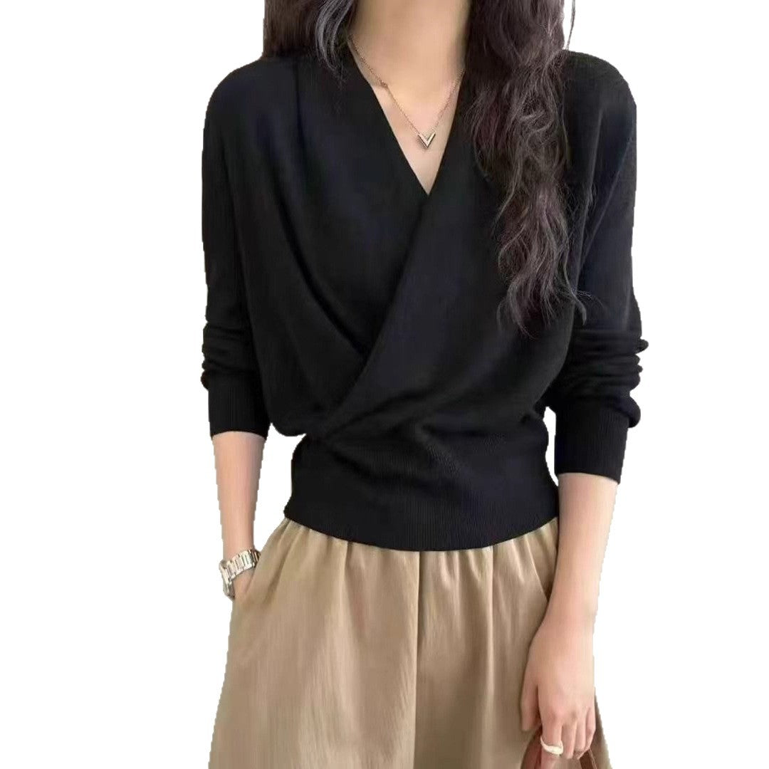 Black crossover V-neck knit sweater front view, crossed panels forming a deep soft V neckline