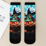 Pair of mid-calf socks printed with a skeleton witch and a glowing jack-o-lantern cauldron on a teal moonlit ground