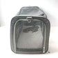 Grey pet carrier end panel in open mesh with a metal D ring on the webbing above the zip