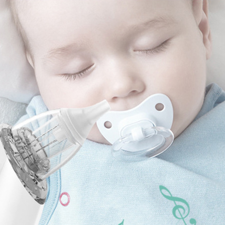 Sleeping baby with a pacifier and the transparent aspirator nozzle held near the nose