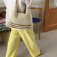 Cream and tan open weave shoulder bag with a zip top and polyester lining