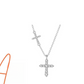 Sterling silver cross pendant necklace resting against a plain studio backdrop