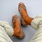 Close view of the criss cross woven upper on a womens flat sandal in matte PU straps