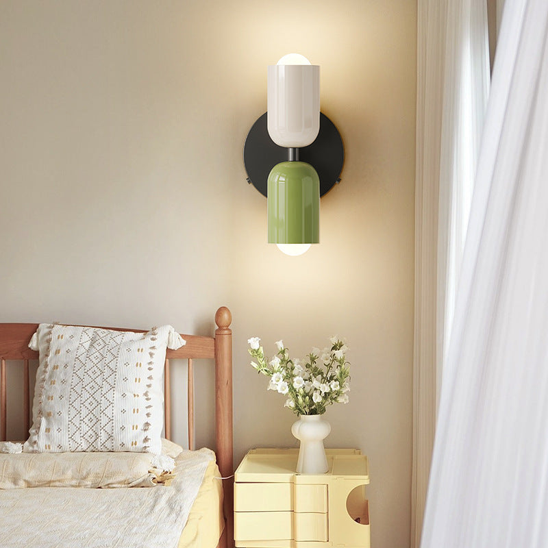 Double head bedside lamp lit on a nightstand with a warm amber glow