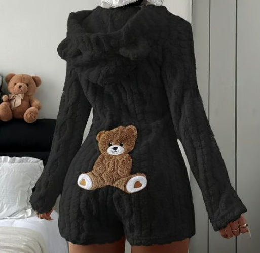 Black plush hooded romper with bear ears and a teddy bear back patch, shown on the Black size M option
