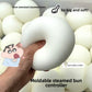 Soft bun-shaped squeeze toy pressed flat between fingers, slow-rebound moldable fidget toy