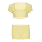 Flat view of the pale yellow U-neck crop top above the fold-over shorts, size M option