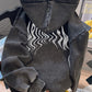 Back view of the washed black hoodie showing the wavy flame print