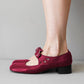 Red Mary Jane shoe with a buckle strap, petal cut outs and a low block heel, side view, size 39 option