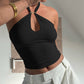 Black halter ring crop top worn with trousers showing the keyhole neckline and fit