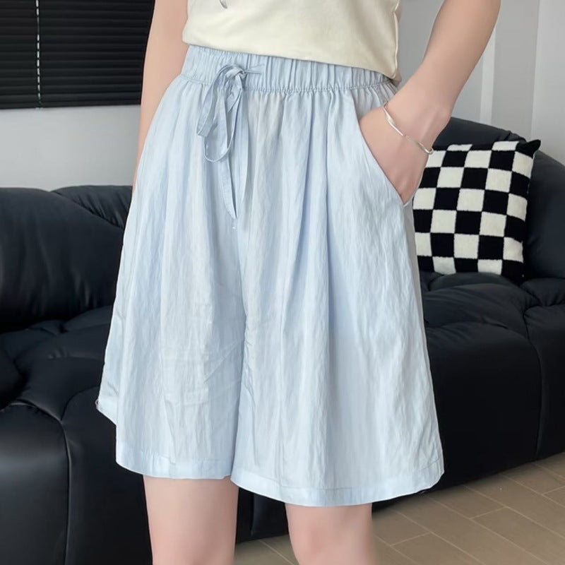 Woman in ice silk pull on shorts showing the drawstring bow and relaxed summer cut