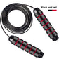 Black and red skipping rope laid flat on white with the coated cable coiled