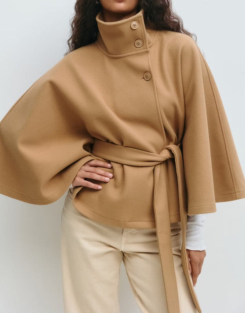 Short cape jacket with cape cut sleeves and a matching self tie belt at the waist