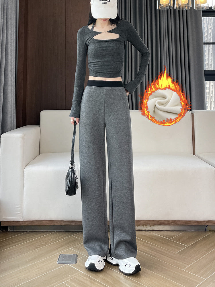 Woman in gray wide-leg pants with a black waistband and a bag, a fleece lining graphic beside her
