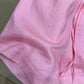 Close up of thin airy pink linen weave on the loose wide-leg shorts