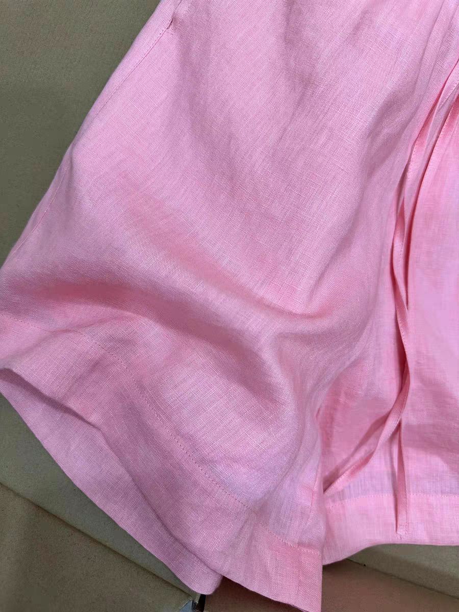 Close up of thin airy pink linen weave on the loose wide-leg shorts