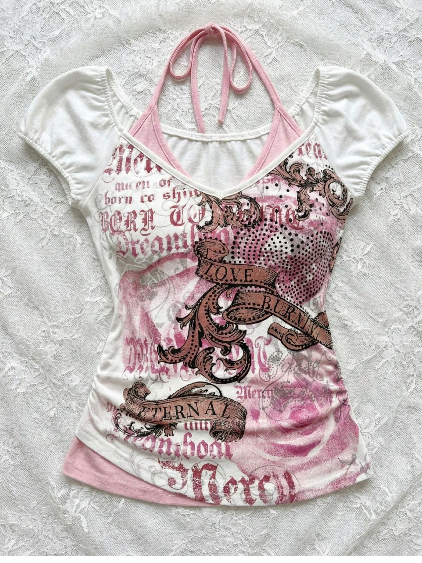 Front flat lay of a slim white short sleeve tee with a pink halter panel and print