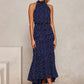 Navy polka dot halter neck sleeveless tiered swing maxi dress worn by a model