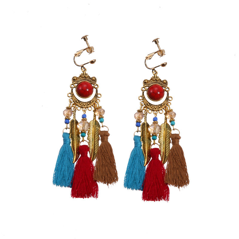 Bohemian tassel and bead clip-on drop earrings, aged tone zinc alloy frame, handmade pair on plain white background