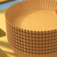 Close up of a single round natural wood pulp air fryer paper liner with pleated sides