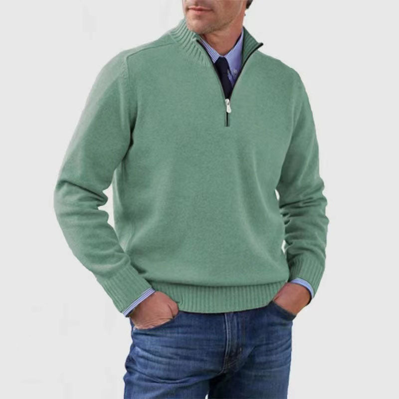 Green mens acrylic knit quarter zip stand collar pullover sweater worn by a standing male model