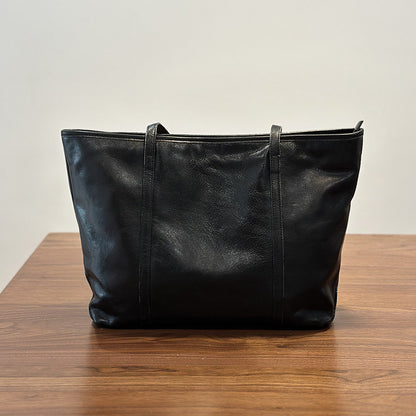 Soft cowhide tote bag shown with its packaging and what the order includes