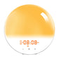 Round wake-up light alarm clock lit in seven different mood colors shown in a row