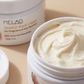 Thick cocoa and shea butter cream in the open Melao jar