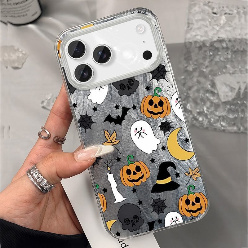 Back of a clear iPhone case showing white ghosts, jack o lanterns and a crescent moon on silver shimmer