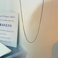 Square Snake Bone Chain Necklace | scale reference next to a hand