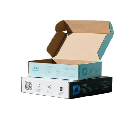 Light blue printed airplane mailer box with its lid open, stacked on a white and black printed box with a QR code