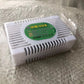 Deodorizer Box option: white vented plastic box with a green label on a woven surface