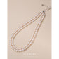 S925 sterling silver round bead necklace on a fine white gold tone chain, front view