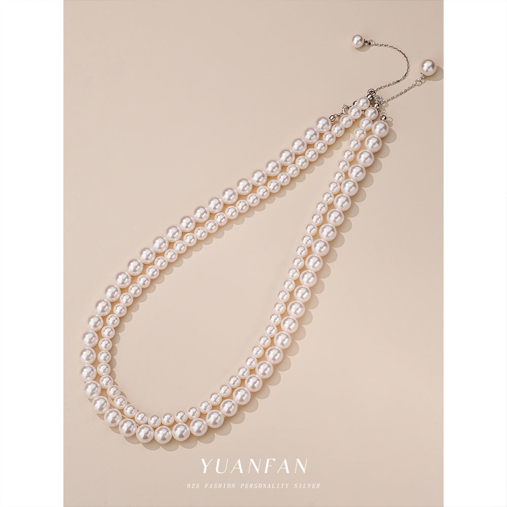 S925 sterling silver round bead necklace on a fine white gold tone chain, front view