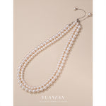 S925 sterling silver round bead necklace on a fine white gold tone chain, front view