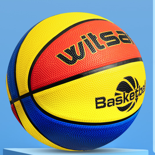 Red yellow and blue rubber basketball for children angled on a bright studio background
