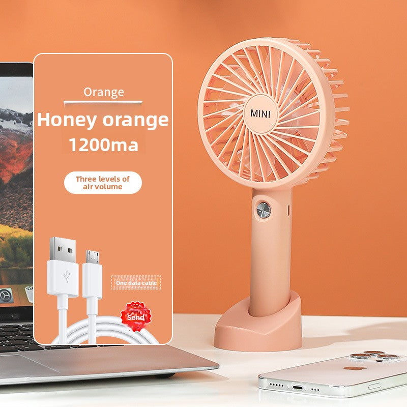 Top down view of the mini USB handheld fan with its blade guard