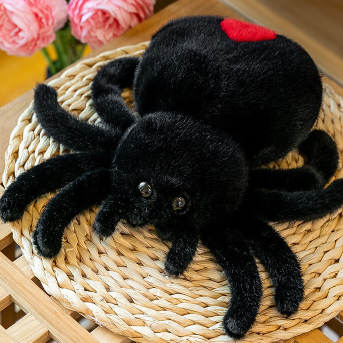 Reversible spider plush shown happy face out with eight short plush legs
