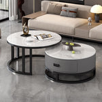 Two round nesting coffee tables with a black frame, white stone tops and a gray drawer cabinet beside a sofa